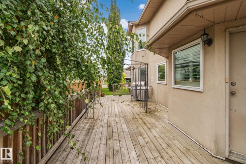 Wood deck with a railing and mature trees - 10 Eldorado Drive, St. Albert, AB 