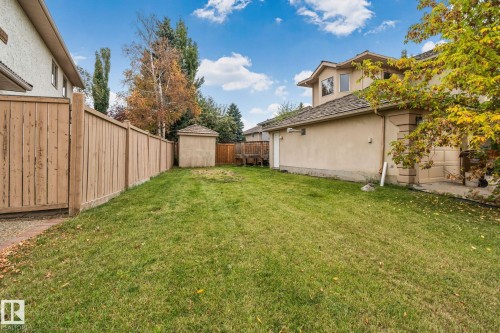 Expansive grassy yard area featuring a storage shed and wood fencing - 10 Eldorado Drive, St. Albert, AB 