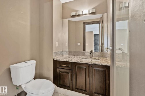 Vanity with granite countertop, undermount sink, and tiled backsplash - 10 Eldorado Drive, St. Albert, AB 