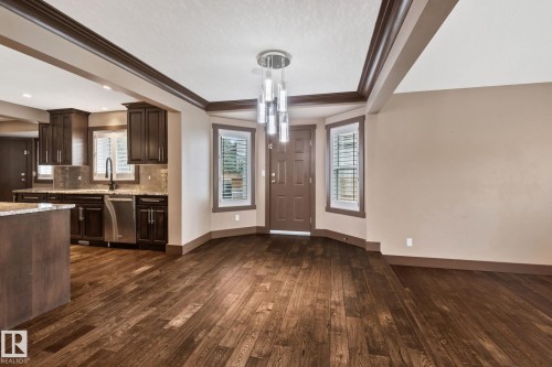 Wood-finish flooring throughout, complemented by a modern pendant light fixture - 10 Eldorado Drive, St. Albert, AB 