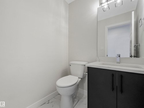 Modern vanity with a light-toned countertop, under-mount sink, and contemporary faucet - 11 Dalquist Bay, Leduc, AB 