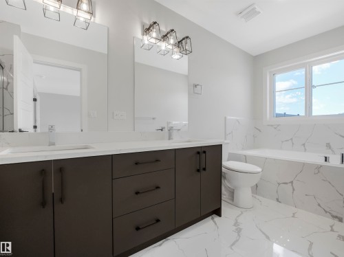 Dual vanity with undermount sinks and white quartz countertops - 11 Dalquist Bay, Leduc, AB 