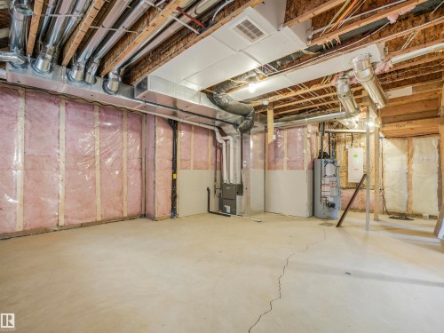 Unfinished basement with concrete flooring, exposed wood joists, and insulated perimeter walls - 11 Dalquist Bay, Leduc, AB 