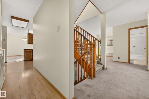 Wood-finish flooring leading to a built-in cabinet - #23 500 Lessard Dr Nw, Edmonton, AB 