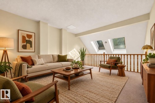 Angled ceiling featuring two skylights, recessed lighting, and a wood-finish railing - #23 500 Lessard Dr Nw, Edmonton, AB 