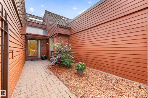 Wood-sided exterior with a tile roof and skylights - #23 500 Lessard Dr Nw, Edmonton, AB 
