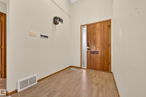 Wood-finish flooring with light-toned wall paint and wood trim - #23 500 Lessard Dr Nw, Edmonton, AB 
