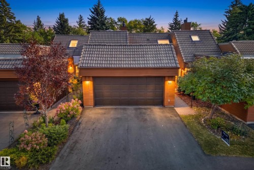 Multi-level roofline with tile roofing, attached garage, skylights, and established landscaping - #23 500 Lessard Dr Nw, Edmonton, AB 