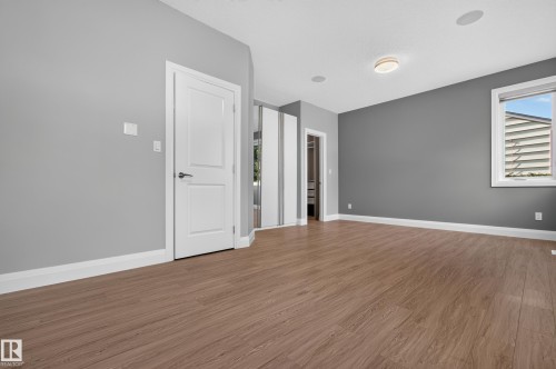 Wood-finish flooring with white trim and a neutral color palette - 11167 62 Avenue Nw, Edmonton, AB 