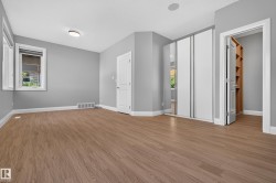 Wood-finish flooring, white trim, recessed lighting, and built-in closet shelving - 
