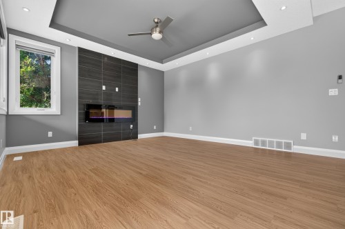 Wood-finish flooring, recessed lighting, and a tray ceiling with a mounted fan - 11167 62 Avenue Nw, Edmonton, AB 