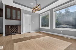 Built-in cabinetry with glass-front uppers and a dedicated wine rack - 