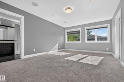 Recessed lighting, flush-mount ceiling light, built-in ceiling speakers, carpeting, and multiple windows - 