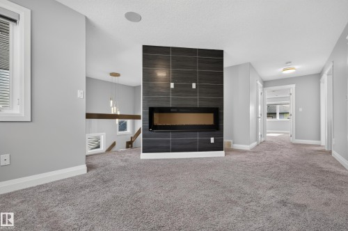 Linear electric fireplace with a dark tile surround - 11167 62 Avenue Nw, Edmonton, AB 