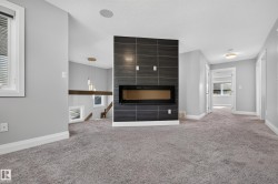 Linear electric fireplace with a dark tile surround - 