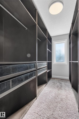 Custom closet system featuring built-in shelving, hanging rods, and drawers - 11167 62 Avenue Nw, Edmonton, AB 