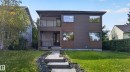 Contemporary exterior featuring wood-finish siding, dark stucco, and a second-story balcony with glass railing - 11167 62 Avenue Nw, Edmonton, AB 