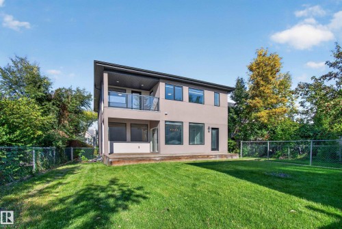 Modern two-story exterior with a neutral-toned facade, black-framed windows, and a glass-paneled balcony - 11167 62 Avenue Nw, Edmonton, AB 