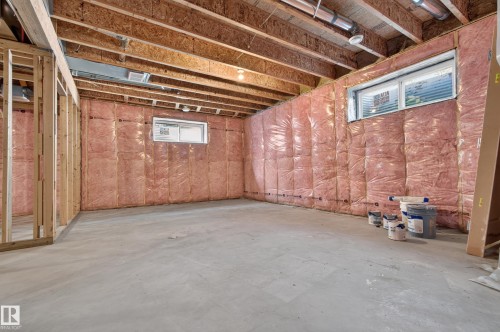 Unfinished basement featuring exposed wood joists, concrete flooring, and insulated walls - 11167 62 Avenue Nw, Edmonton, AB 