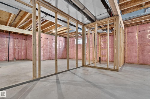 Unfinished basement with concrete flooring, exposed wood framing, and pink insulation - 11167 62 Avenue Nw, Edmonton, AB 