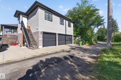 Two-story residence with stucco exterior and black trim windows - 