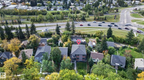 Property featuring a multi-story structure with a dark roof and a green lawn - 11167 62 Avenue Nw, Edmonton, AB 