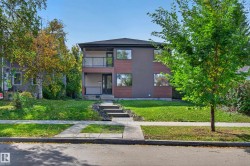 Contemporary exterior with mixed-material facade, featuring a second-story balcony with a glass railing, a covered entryway, and a stone walkway - 