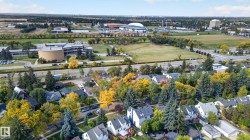Residential properties surrounded by mature trees, with nearby academic buildings and athletic facilities - 