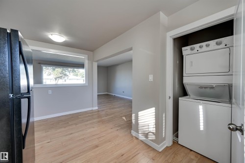 Wood-finish flooring throughout, with a pass-through window opening - 13815 88 Street Nw, Edmonton, AB 