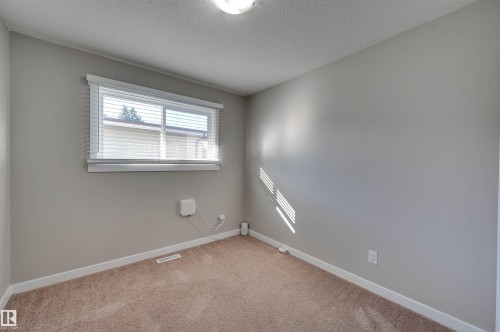 Neutral wall paint, window with horizontal blinds, and carpet flooring - 13815 88 Street Nw, Edmonton, AB 