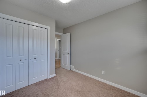 Neutral-toned walls, plush carpeting, and white trim - 13815 88 Street Nw, Edmonton, AB 