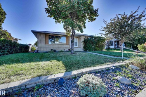 Brick exterior with a prominent front window and sloped roofline - 13815 88 Street Nw, Edmonton, AB 