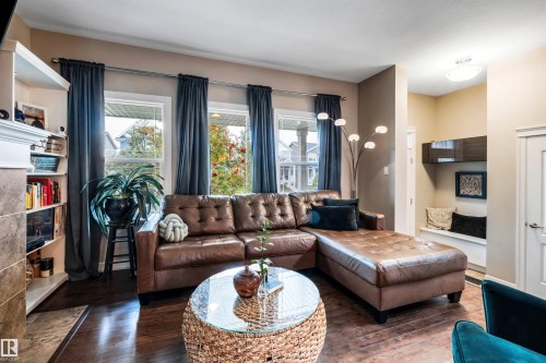 Rich wood-finish flooring throughout, complemented by a built-in window bench with overhead cabinetry - 337 Southfork Drive, Leduc, AB 