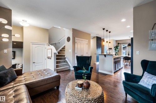 Hardwood-finish flooring throughout, complemented by recessed lighting and a built-in kitchen island featuring pendant lighting - 337 Southfork Drive, Leduc, AB 