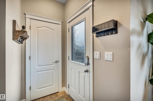 White paneled interior door, frosted glass exterior door, and light-toned walls - 337 Southfork Drive, Leduc, AB 