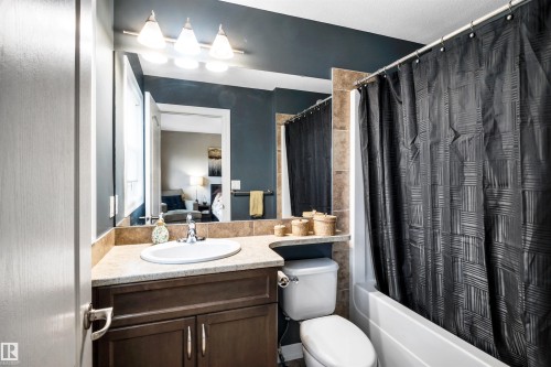 Built-in vanity with a light-toned countertop and under-mount sink - 337 Southfork Drive, Leduc, AB 