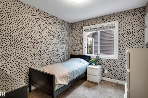 Patterned accent wall, white-framed window, window blinds, and carpeted flooring - 337 Southfork Drive, Leduc, AB 