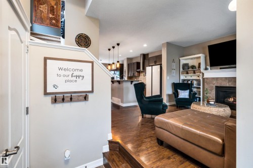 Hardwood flooring, built-in fireplace, tile hearth, white mantel, recessed lighting - 337 Southfork Drive, Leduc, AB 
