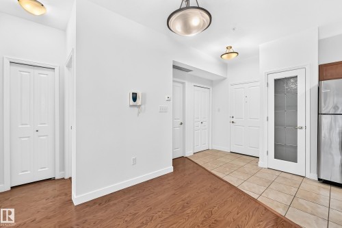 Wood-finish flooring, white walls, and a tiled entry - #307 1003 Gault Bv Nw, Edmonton, AB 