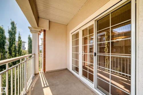 Private balcony with a concrete surface, white metal railing, and a decorative column - #307 1003 Gault Bv Nw, Edmonton, AB 