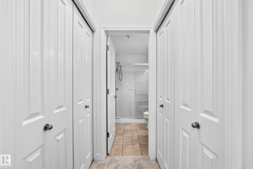 White paneled doors with dark hardware - #307 1003 Gault Bv Nw, Edmonton, AB 