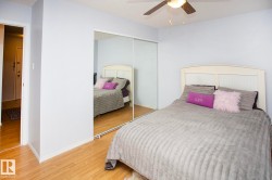 Wood-finish flooring with a ceiling fan and light fixture - 