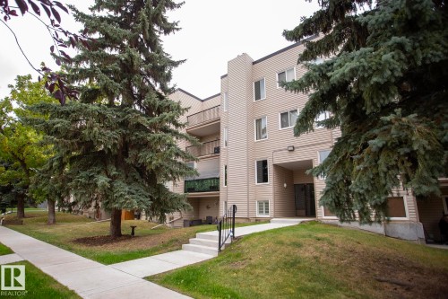 Multi-story building featuring horizontal siding, multiple balconies, and an entry alcove - #407 9810 178 St Nw, Edmonton, AB 