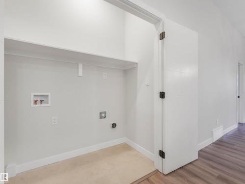 Utility alcove with a built-in shelf, plumbing hookups, and electrical outlets - 36 Dalquist Bay, Leduc, AB 