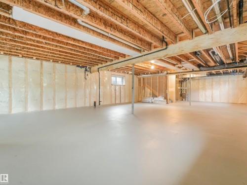 Unfinished lower level featuring exposed wood joists, concrete flooring, and framed walls with insulation - 36 Dalquist Bay, Leduc, AB 