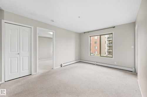 Neutral-toned walls complement the light-colored carpeting - #215 11804 22 Av Sw, Edmonton, AB 