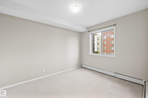 Neutral wall tones, light-colored carpeting, and a window with white trim - #215 11804 22 Av Sw, Edmonton, AB 