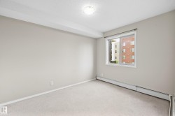 Neutral wall tones, light-colored carpeting, and a window with white trim - 