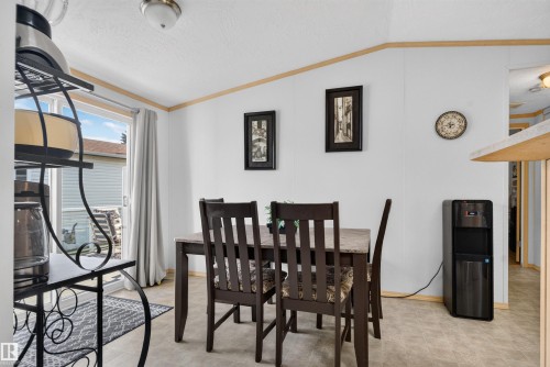 Sliding glass door, durable flooring, ceiling-mounted light fixture, wood-finish trim, and white wall panels - 1405 53222 Range Road 272, Rural Parkland County, AB 