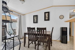 Sliding glass door, durable flooring, ceiling-mounted light fixture, wood-finish trim, and white wall panels - 